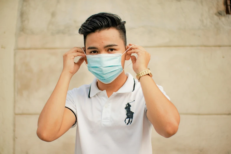 a man with a face mask covering his eyes, pexels contest winner, wearing polo shirt, young cute wan asian face, white and teal garment, medical