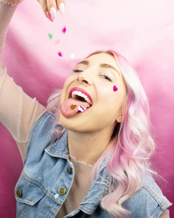 a woman with pink hair eating a donut, trending on pexels, confetti, hearts, laughing maniacally, non binary model