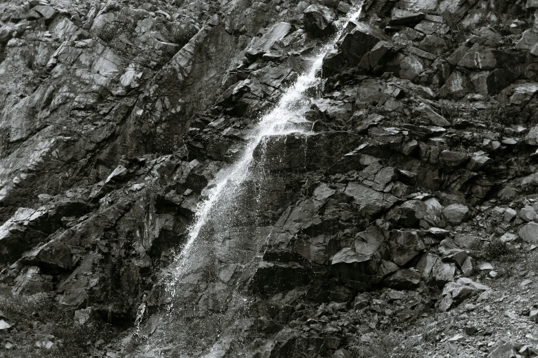 a black and white photo of a waterfall, a black and white photo, inspired by Thomas Struth, figuration libre, mountainside, landslides, medium format film photography, low detail