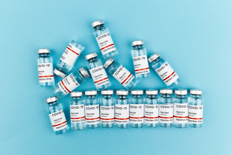 a bunch of vials sitting on top of a blue surface, medical labels, on a gray background, thumbnail, profile pic