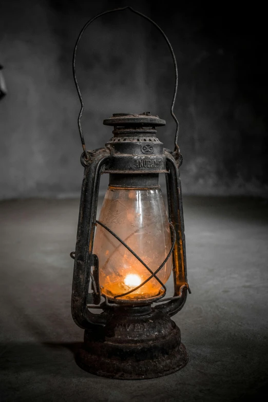 an old lantern with a lit candle in it, a portrait, unsplash, museum photo, looking menacing, grey, rustic