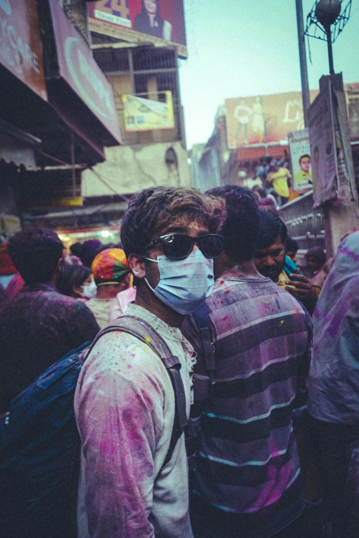 a group of men standing next to each other on a street, a colorized photo, pexels contest winner, happening, rainbow colored dust mask, hindu aesthetic, wearing goggles, selfie of a man