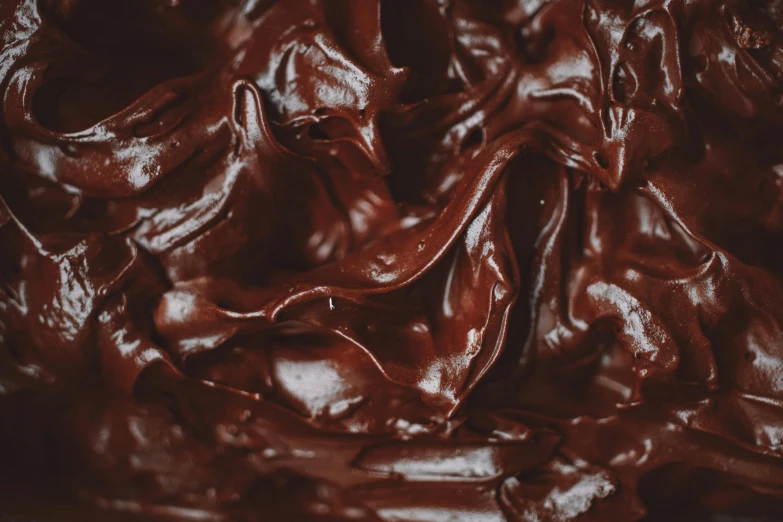 a close up of a chocolate frosted cake, by Nick Fudge, trending on pexels, process art, covered with black goo, thumbnail, handcrafted, background image