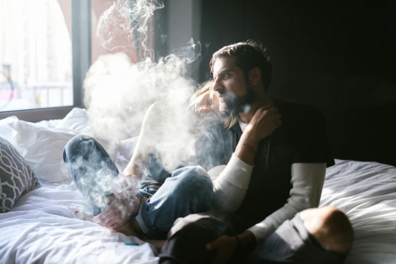 a man sitting on a bed smoking a cigarette, inspired by Elsa Bleda, pexels contest winner, renaissance, smoking a bowl of hash together, couple on bed, smoke and gas, hunter biden smoking crack