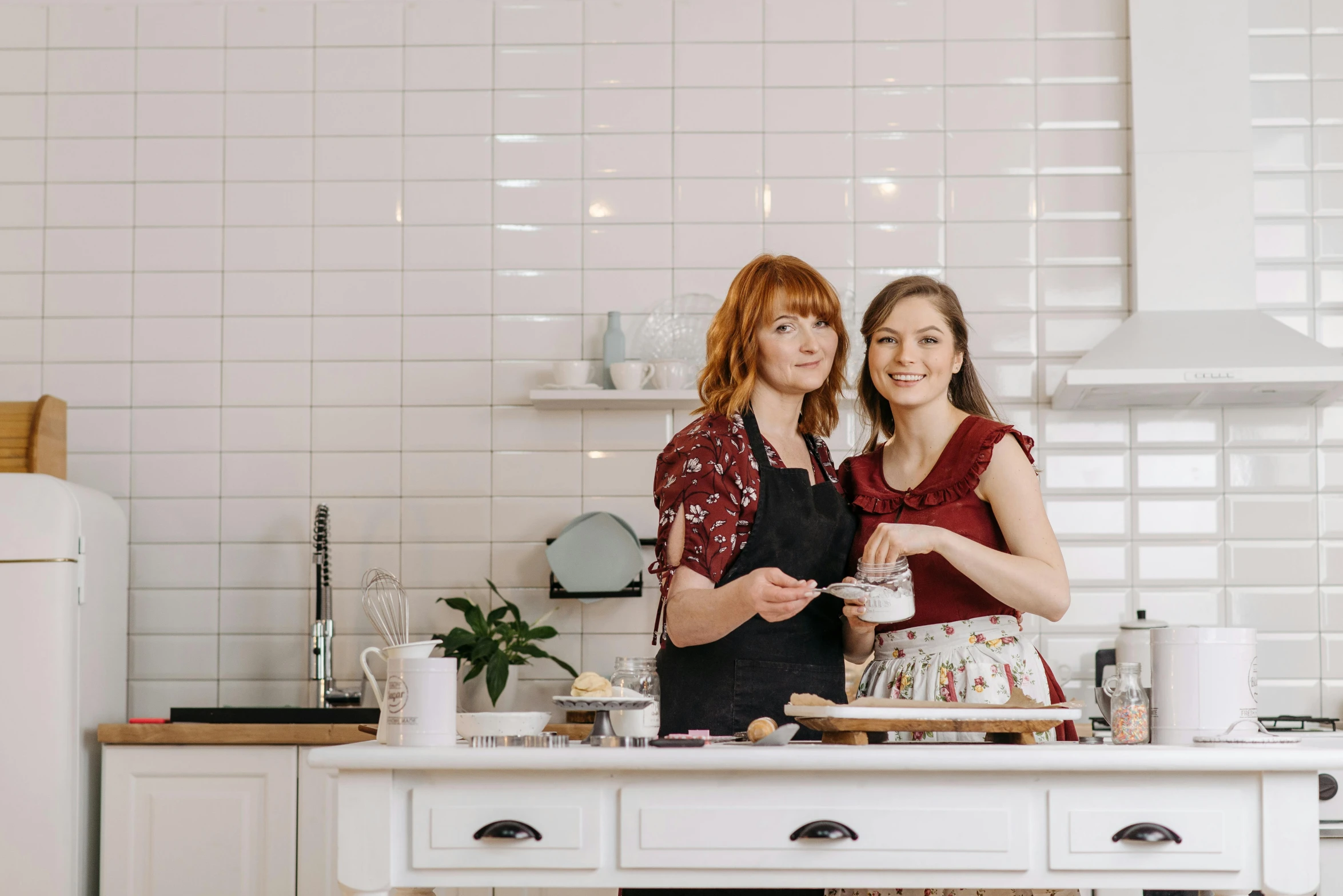 a couple of women standing next to each other in a kitchen, a portrait, by Julia Pishtar, pexels, art nouveau, white backround, food stylist, avatar image, hands on counter