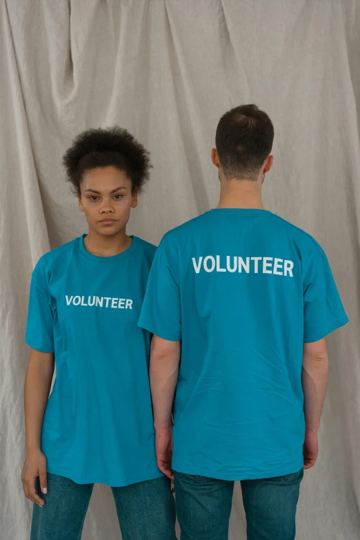 a couple of young men standing next to each other, an album cover, by Ellen Gallagher, unsplash, sport t-shirt, teal uniform, !female, virgil abloh