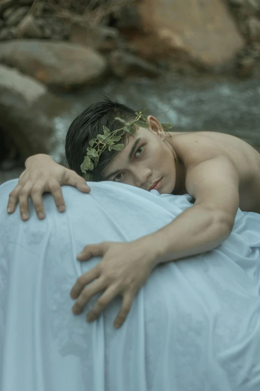a man laying on top of a bed next to a river, by Basuki Abdullah, unsplash, renaissance, delicate androgynous prince, two men hugging, portrait shot 8 k, ( ( ( ( kauai ) ) ) )