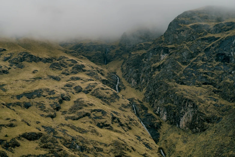 a herd of sheep standing on top of a lush green hillside, an album cover, pexels contest winner, hurufiyya, mysterious canyon streams, scottish highlands, thumbnail, overcast