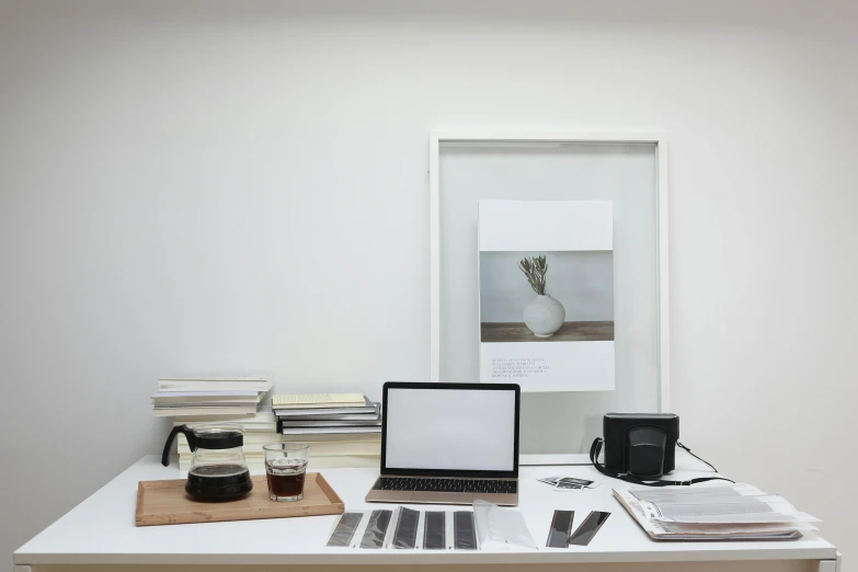 a laptop computer sitting on top of a white desk, a minimalist painting, inspired by Harvey Quaytman, nadav kander, ameera al-taweel, overview, minimal kitchen