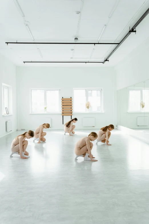 a group of naked people in a dance studio, an album cover, unsplash, purism, ignant, sweden, pregnancy, crouching