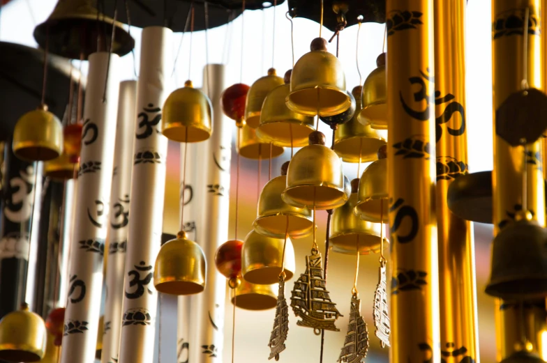 a bunch of bells hanging from a ceiling, by Julia Pishtar, unsplash, cloisonnism, pagoda with a lot of wind chimes, 🦩🪐🐞👩🏻🦳, tall golden heavenly gates, thumbnail