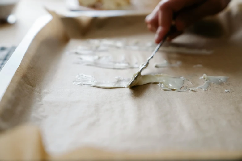 a person cutting a piece of cake with a knife, a detailed painting, by Jessie Algie, unsplash, process art, silver，ivory, on old parchment paper, melted cheese, glazing