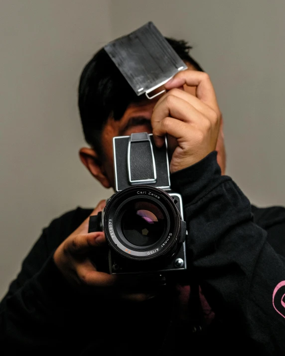 a man taking a picture with a camera, by Robbie Trevino, studio medium format photograph, ilustration, cute photo, dark photo