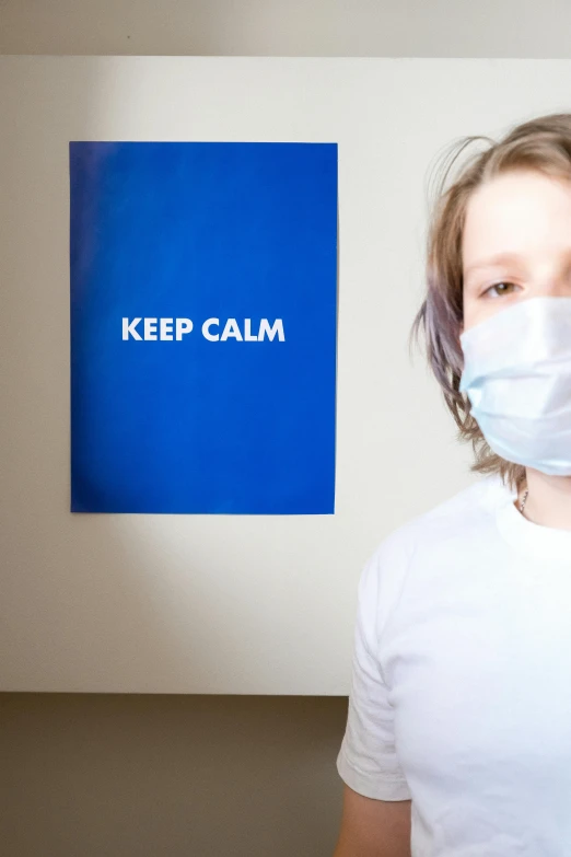 a person wearing a face mask in a room, inspired by Gottfried Helnwein, pexels, barron trump, wearing a hospital gown, hidden message, calm environment