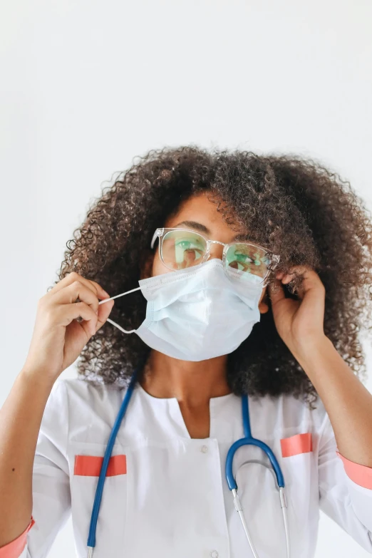 a woman wearing a face mask and a stethoscope, inspired by Dr. Atl, trending on pexels, happening, with square glasses, ashteroth, wearing a white hospital gown, thumbnail