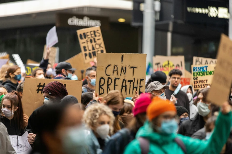 a crowd of people holding signs that read i can't breathe, trending on pexels, new zealand, brown, thumbnail, people walking