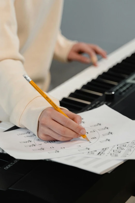 a person sitting at a piano with a pencil in their hand, charts, promo image, schools, no - text no - logo