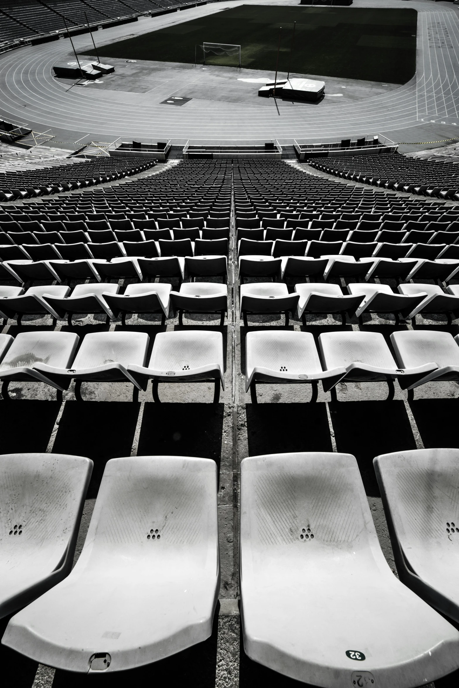 a black and white photo of a baseball stadium, inspired by Andreas Gursky, unsplash contest winner, old chairs, ( ( photograph ) ), mexico city, concert