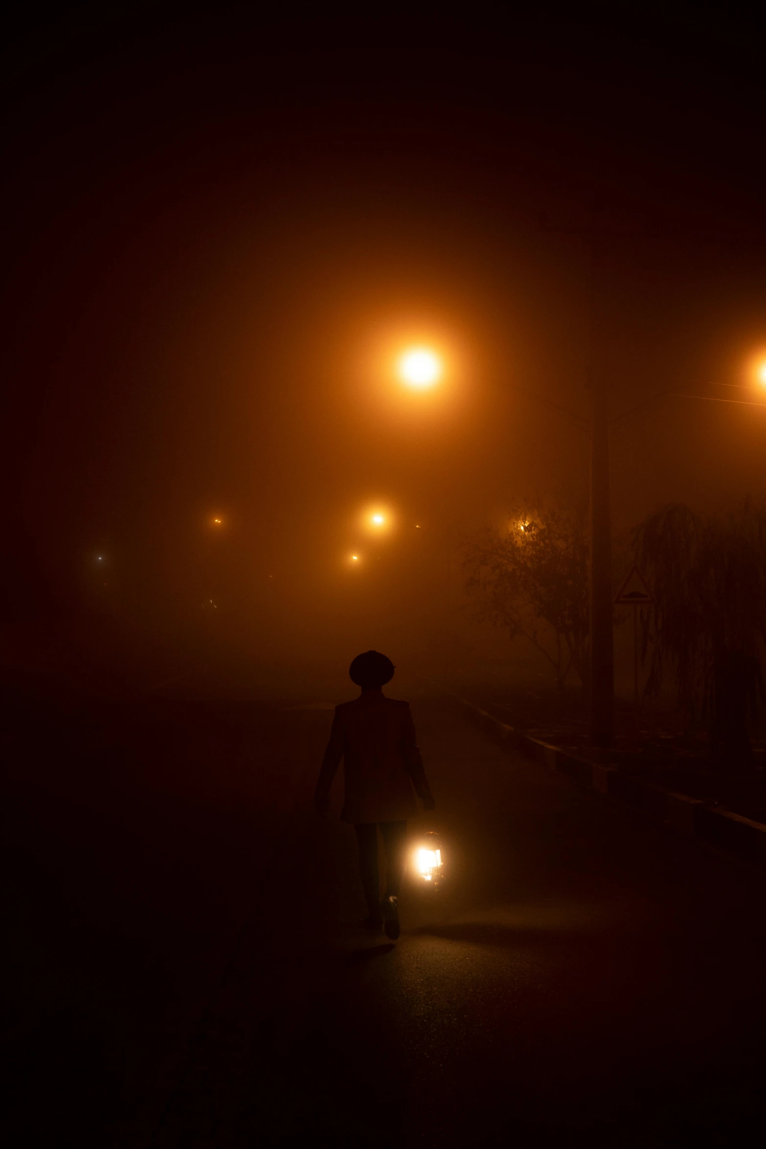 a person walking down a street at night, by Ahmed Yacoubi, ((mist)), nightlight, (mist)