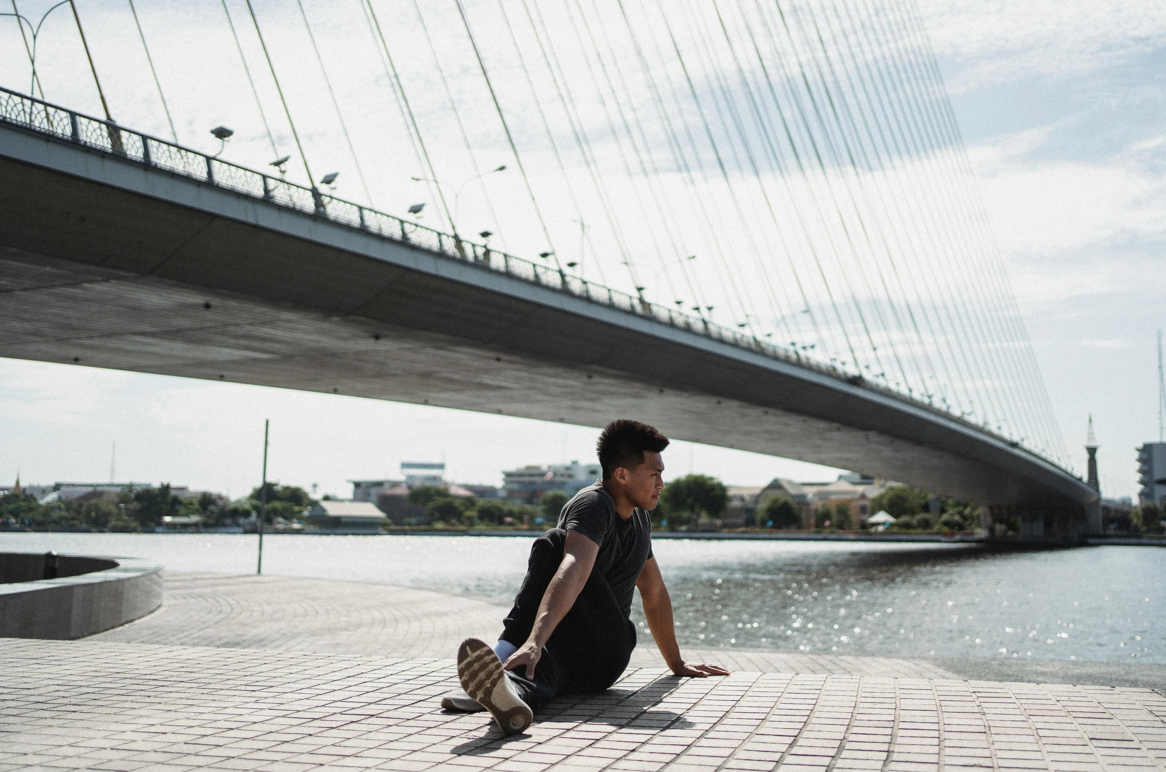 a man that is sitting down on a skateboard, inspired by Kōno Michisei, pexels contest winner, happening, sitting under bridge, workout, plain stretching into distance, profile image