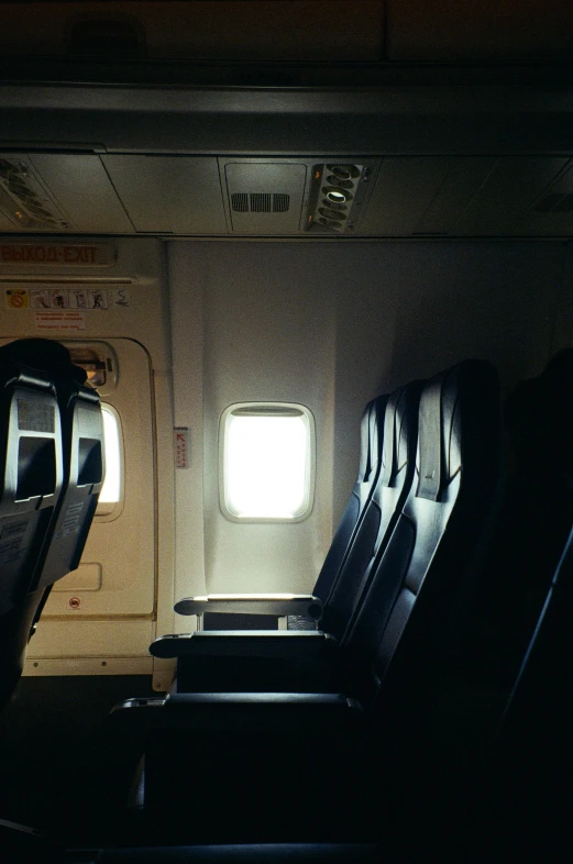 a row of empty seats in an airplane, by Jessie Algie, unsplash, light and space, light coming from windows, vandalism, snapchat photo, multiple stories