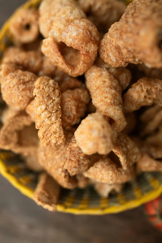 a bowl filled with fried food on top of a table, sandworm, up close, cheerios, various sizes