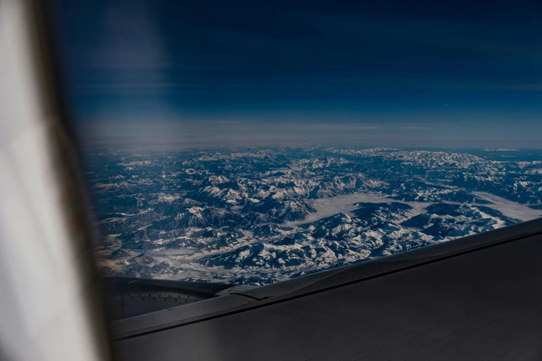 a view of mountains from an airplane window, by Matthias Weischer, pexels contest winner, precisionism, blue marble, distant mountains lights photo, highly detailed photo 4k, rectangle