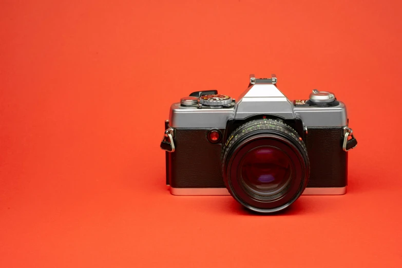 a camera sitting on top of a red surface, a picture, 80s photo, high-quality dslr photo”, medium - shot, photography”