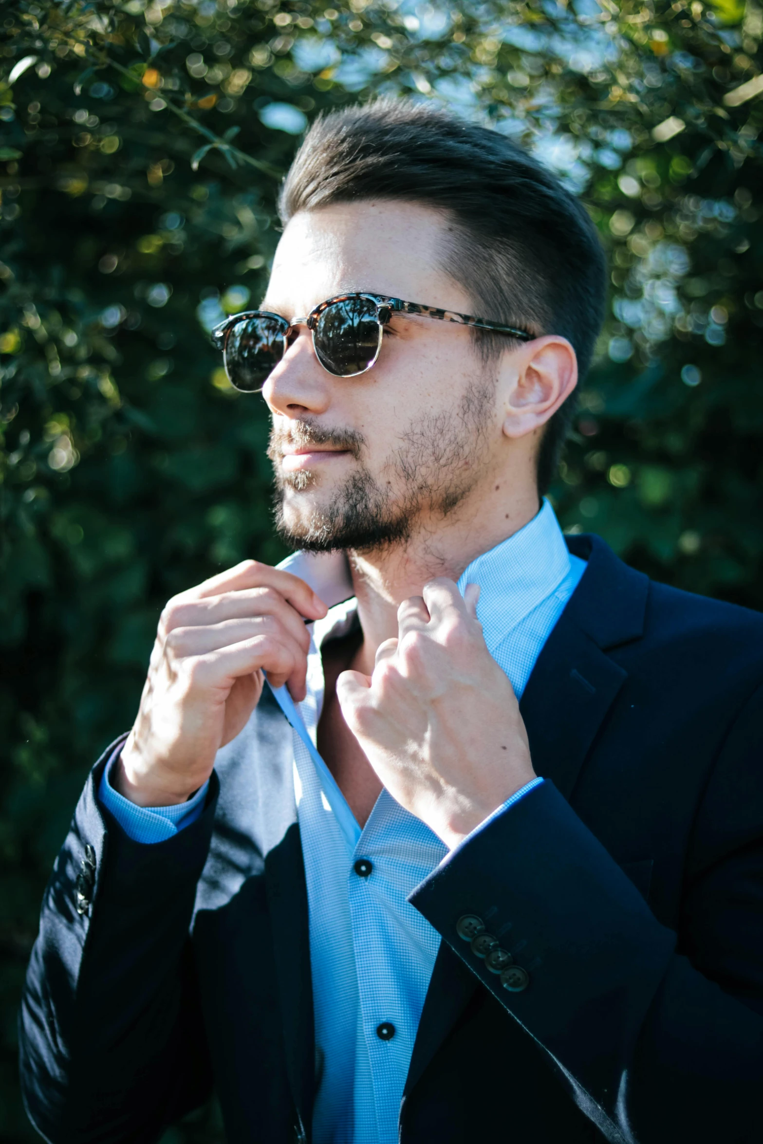 a man in a suit and sunglasses adjusting his tie, by Niko Henrichon, unsplash, handsome young man, slide show, multiple stories, profile image