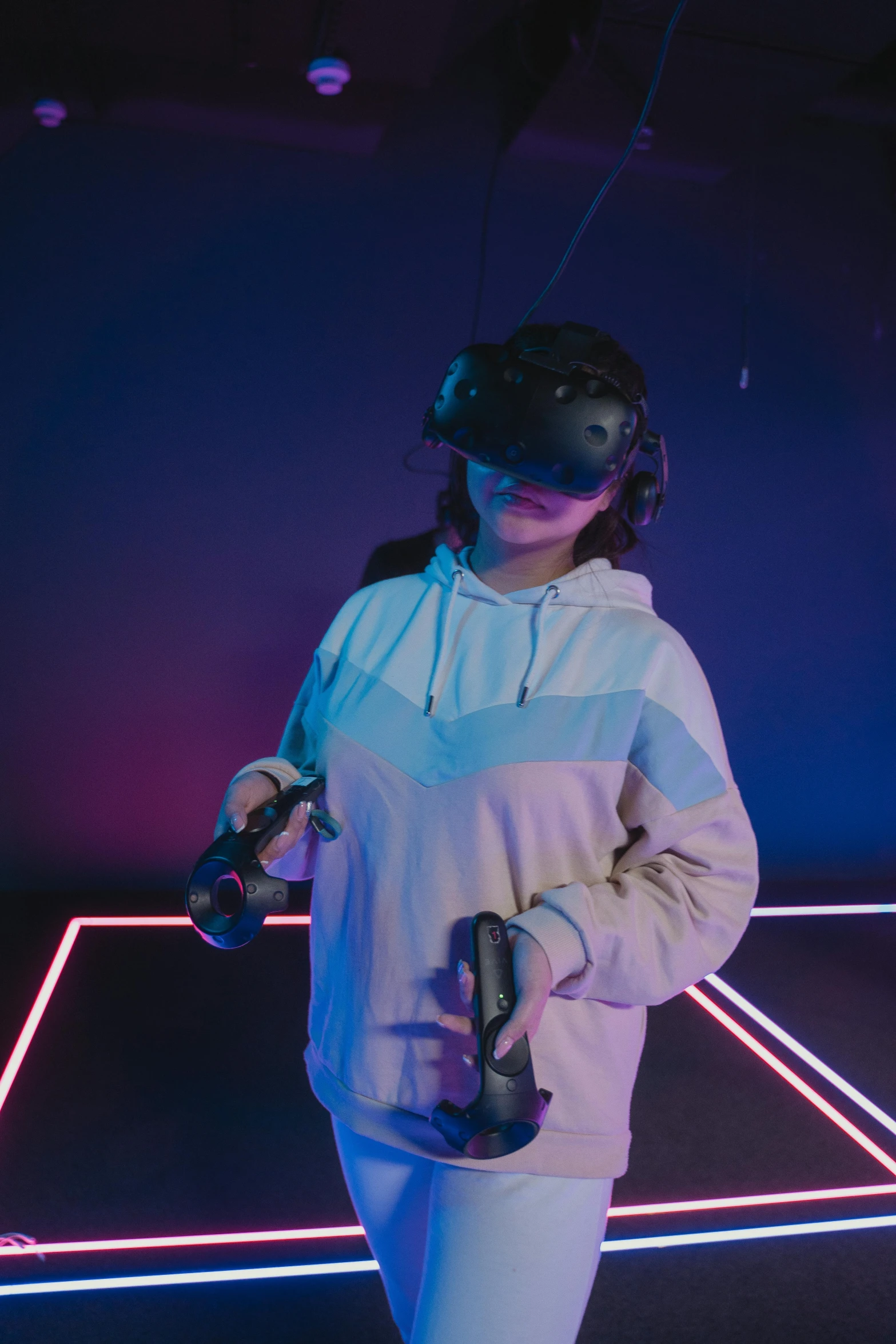 a woman standing on top of a tennis court holding a racquet, a hologram, by Adam Marczyński, pexels contest winner, interactive art, wearing a gaming headset, vr helmet on man, standing in a dimly lit room, tiktok