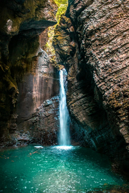 a waterfall in the middle of a canyon, inside a gorge, rock pools, paul barson, turquoise water