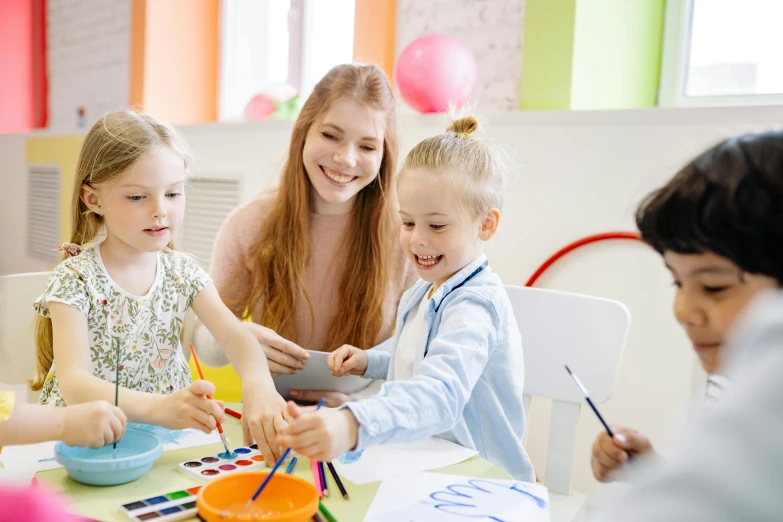 a group of children sitting around a table