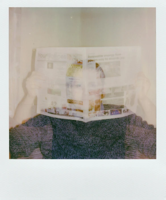 a person holding a newspaper in front of their face, a polaroid photo, transparent body, slightly pixelated, block head, on a pale background