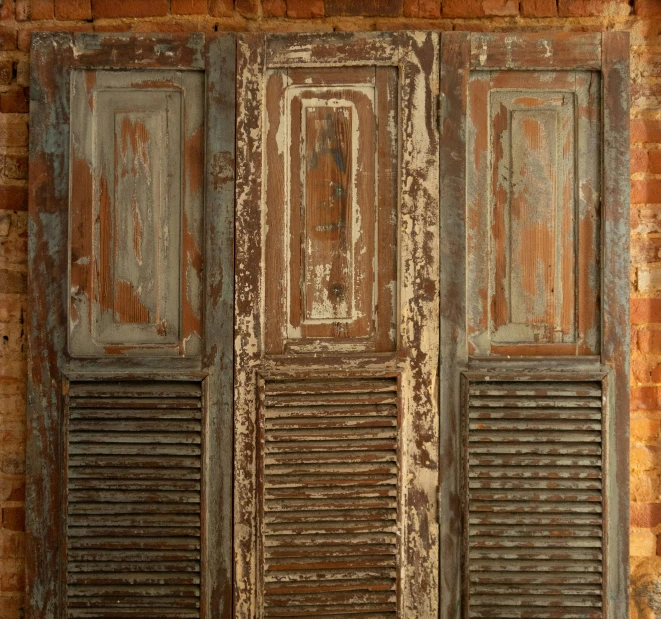 an old window with shutters on a brick wall, by David Simpson, unsplash, triptych, oil on aged tin, cairo, two wooden wardrobes