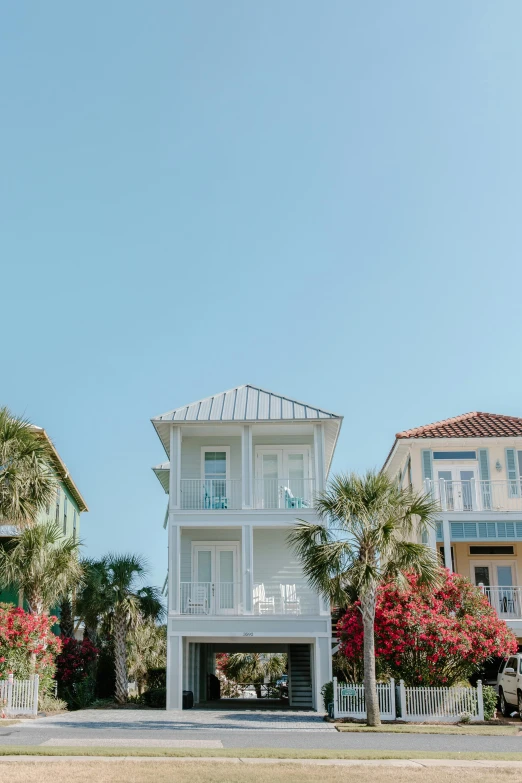 a couple of houses sitting on the side of a road, unsplash, visual art, the emerald coast, low quality photo, vacation photo, square