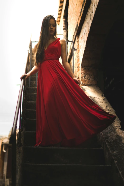 a woman in a red dress walking up a flight of stairs, pexels contest winner, renaissance, long dress female, 15081959 21121991 01012000 4k, beautiful silky dress, boho
