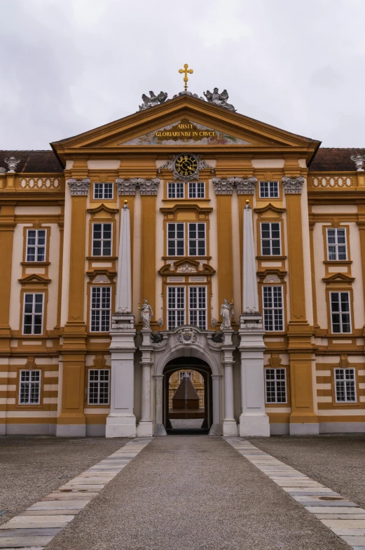 a large building with a clock on top of it, inspired by Johann Ludwig Aberli, baroque, huge gate, ocher, private academy entrance, citadel