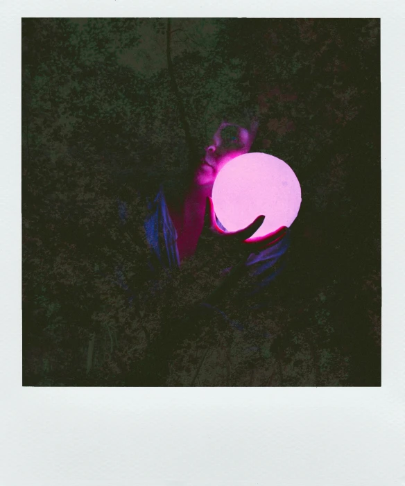 a person holding a pink frisbee in their hand, a polaroid photo, inspired by Elsa Bleda, unsplash, conceptual art, bioluminescent orbs, purple and green fire, forest and moon, flash color polaroid