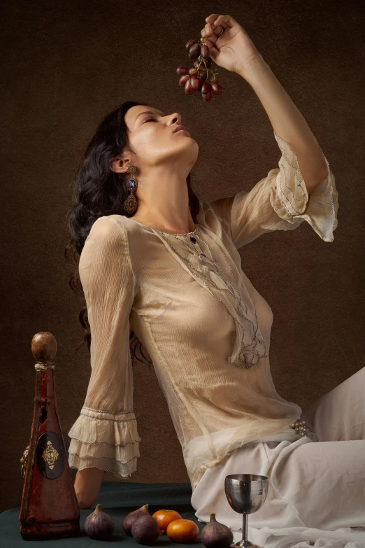 a woman sitting on a table holding a bunch of grapes, inspired by Anka Zhuravleva, renaissance, cream colored blouse, dressed in a frilly ((lace)), sheer fabrics, vintage fashion