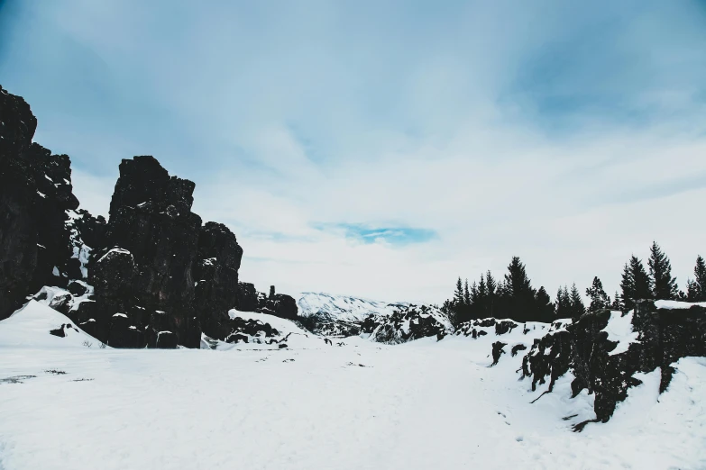 a man riding skis down a snow covered slope, pexels contest winner, visual art, with jagged rocks & eerie, an icelandic landscape, sparse winter landscape, black