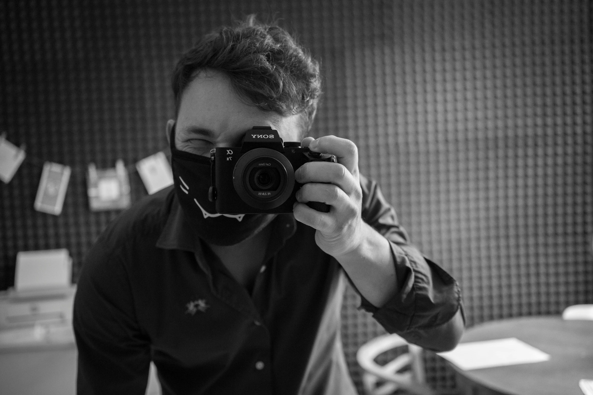 a man taking a picture of himself with a camera, a black and white photo, by Adam Marczyński, wearing facemask, avatar image, professional photo, low quality photograph