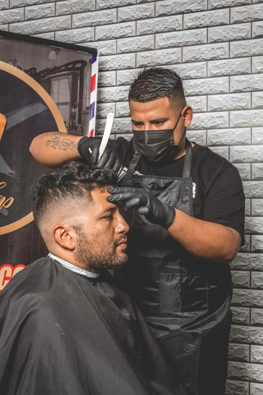 a man getting his hair cut at a barber shop, by Robbie Trevino, hands shielding face, aztec hair, backdrop, balaclava