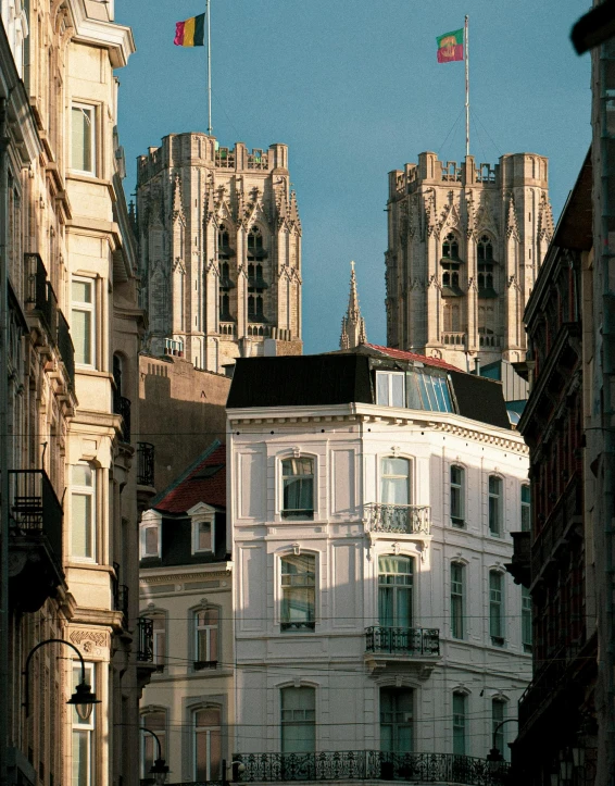 a couple of buildings that are next to each other, an album cover, by Johan Grenier, unsplash, renaissance, in 2 0 0 2, brussels, behind her a gothic cathedral, late afternoon