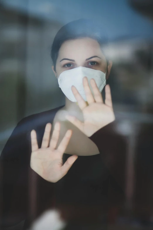 a woman wearing a face mask looking through a window, by Arabella Rankin, shutterstock, square, solemn gesture, (doctor), no cropping