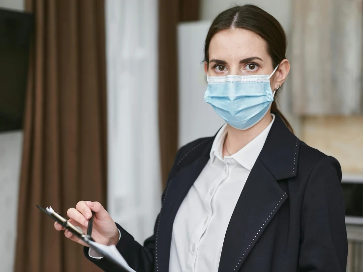 a woman wearing a face mask and holding a clipboard, a portrait, by Emma Andijewska, pexels contest winner, business attire, hospital, decoration, thumbnail