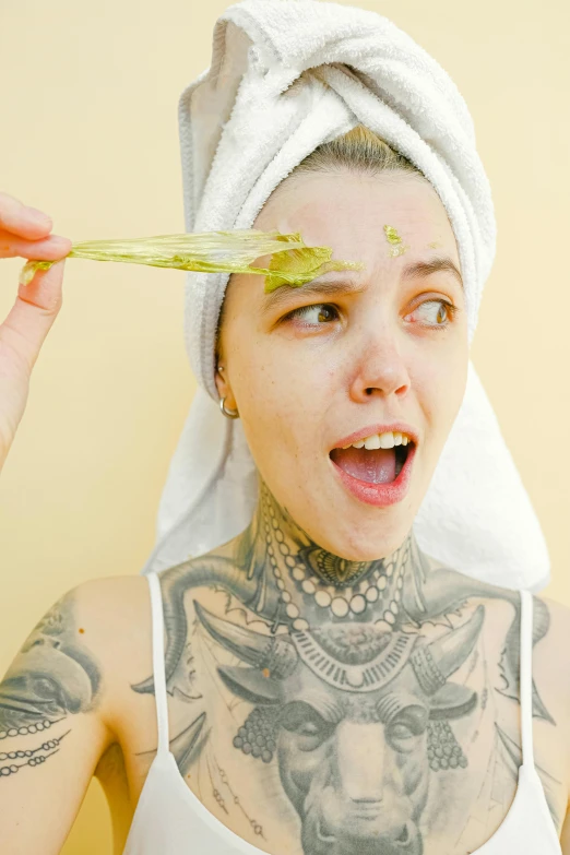 a close up of a person with a towel on their head, a tattoo, green skin, wearing honey, clean hair, hemp