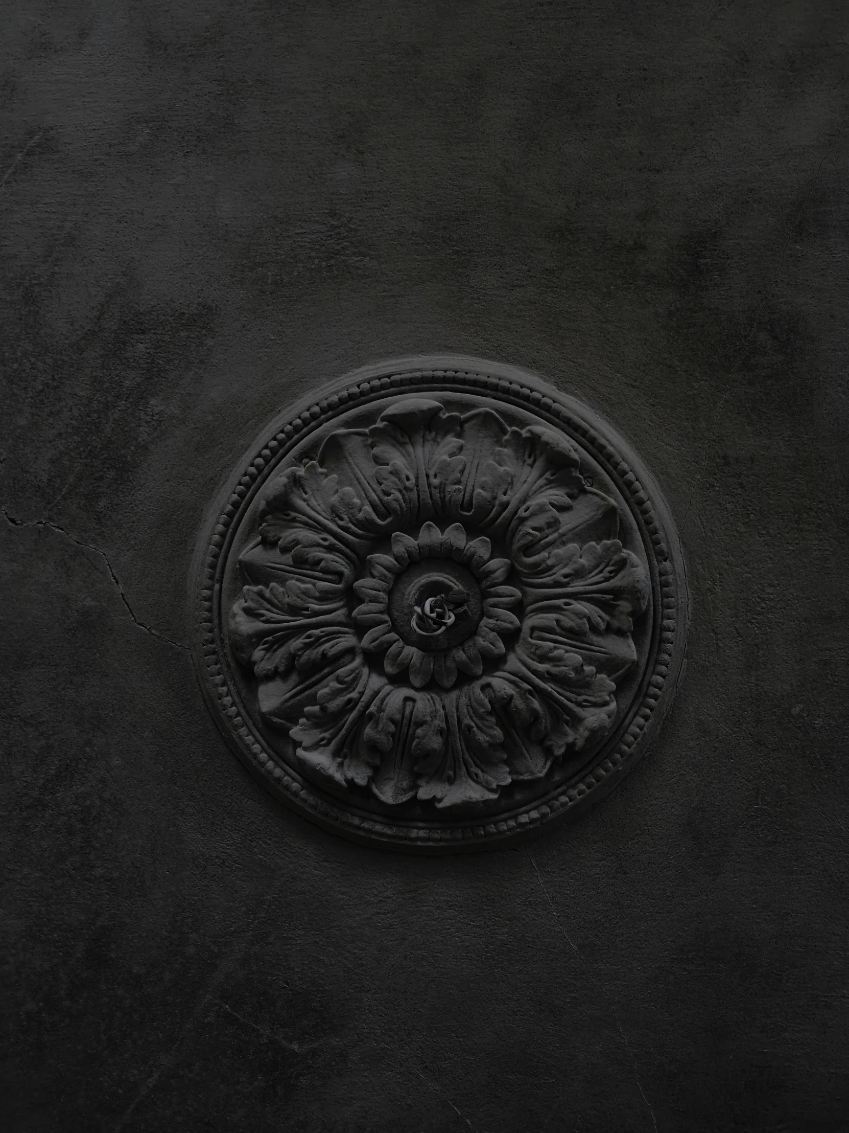 a black vase sitting on top of a table, an album cover, inspired by Antoine Verney-Carron, unsplash contest winner, baroque, detail texture, rosette, made of concrete, detailed product image