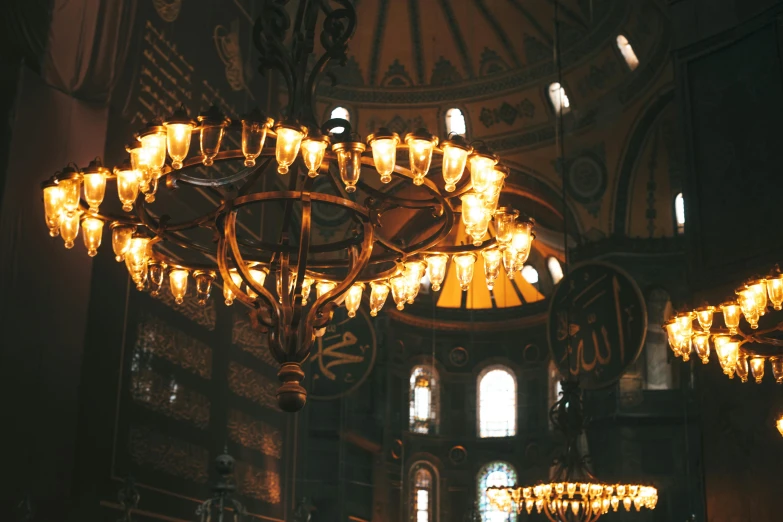a large chandelier hanging from the ceiling of a building, inspired by Elsa Bleda, unsplash contest winner, turkey, orthodox icons, youtube thumbnail, 🦩🪐🐞👩🏻🦳