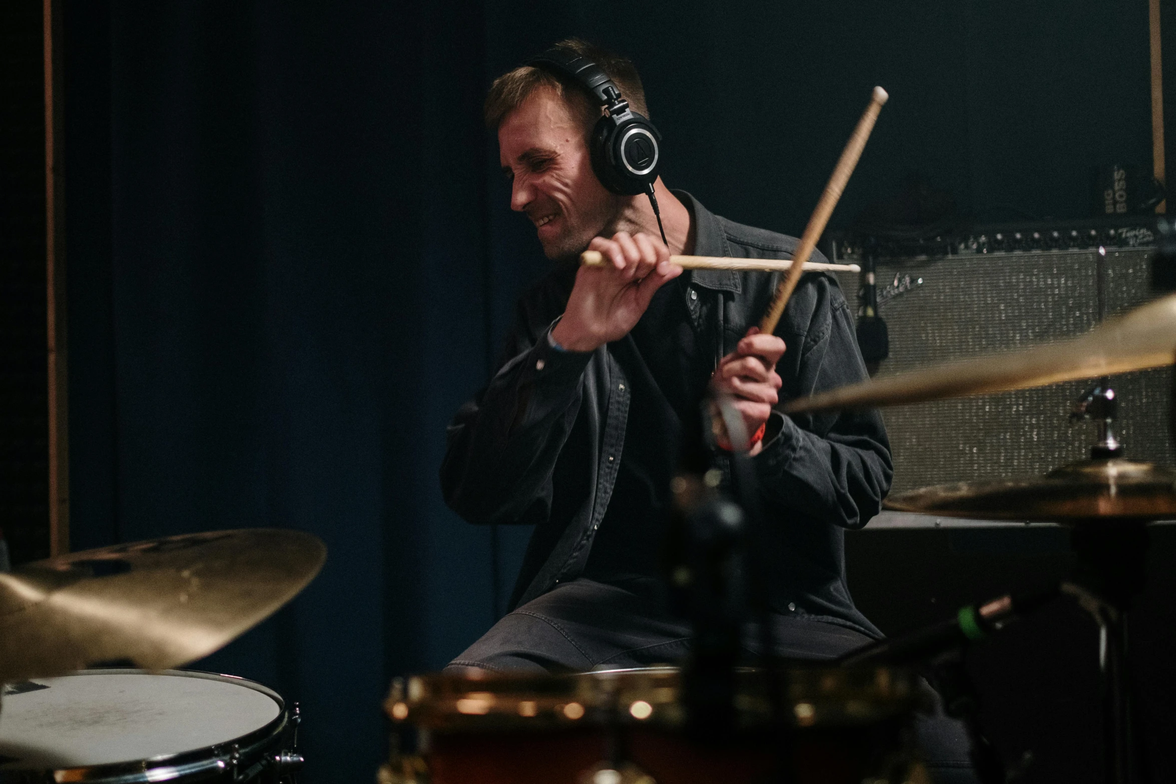 a man playing drums in a recording studio, an album cover, unsplash, photorealism, lachlan bailey, profile image, performance, solid background