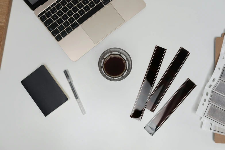 a laptop computer sitting on top of a white desk, film stills, brown, flatlay, 9216k film